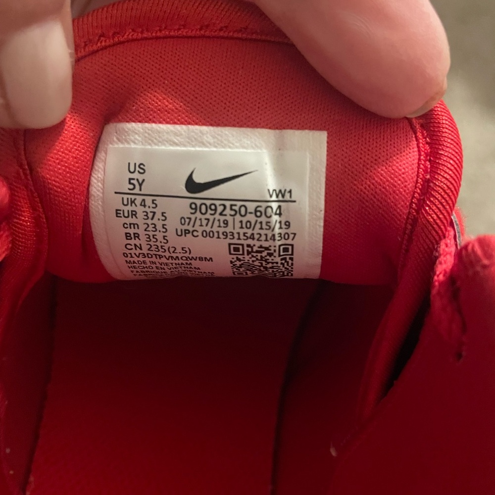Boys red Nike tennis shoes